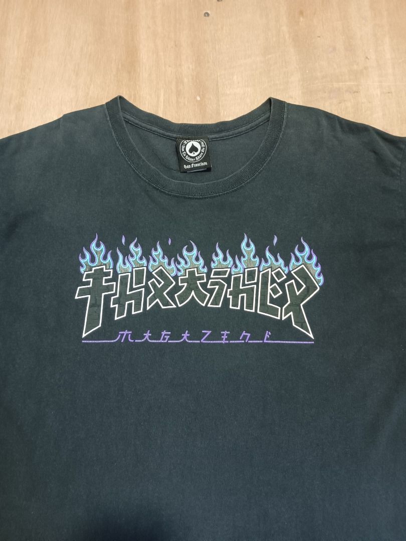 Thrasher Flame Graphic Black T-Shirt (Category: Tshirts & Polo Shirts ) located in Bulacan. Submitted by ken2thrift (Listing ID 1466806108, Image 2). Description: - Color: Black - Design: Blue flame graphic across the chest - Fit: Standard casual fit - Measurements (laid flat): Pit to pit - 20 inches | Length - 29 inches - Condition: Good - Mode of Payment: GCash - Shipping: Via LALAMOVE, J&T or LBC (Buyer shoulders fee).