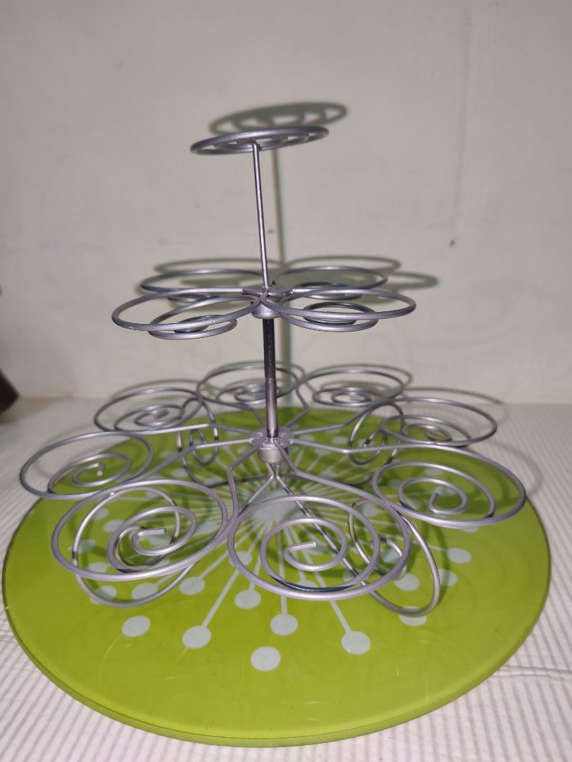 Tiered Metal Cupcake Stand with Green Base (Category: Bakeware) located in Manila. Submitted by reascheyss51406 (Listing ID 1466789389, Image 3). Description: - Multi-tier silver metal wire cupcake stand - Features a cheerful bright green baseplate with white polka dots - Spiral levels securely hold multiple cupcakes - Sturdy and durable metal construction - Easy to set up and take down - Ideal for birthday parties, bake sales, and tea gatherings