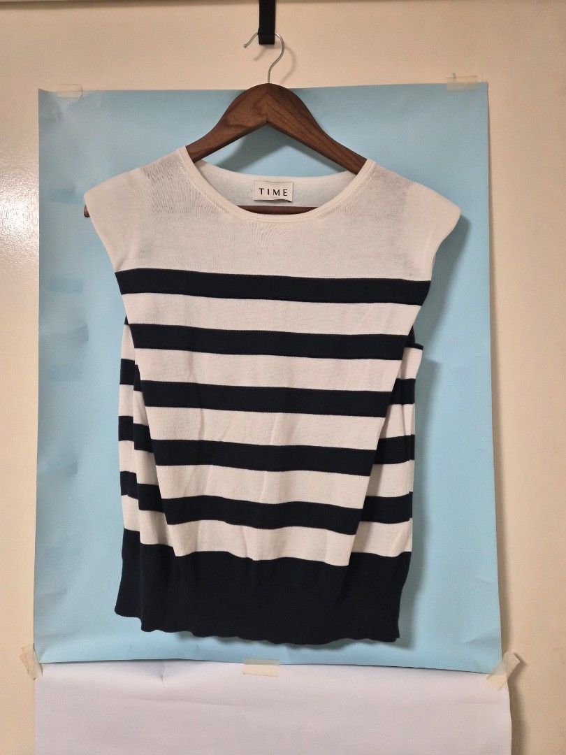 TIME Striped Knit Sleeveless Top (Category: Sleeveless) located in Manila. Submitted by prelovedbyc.hannah (Listing ID 1466923292, Image 1). Description: - Brand/Style: TIME striped knit sweater in cream and navy blue - Design: Classic sailor stripe pattern with a round neckline, short sleeves, and ribbed hem and cuffs - Condition: Pre-loved with a couple of tiny faint spots near the collar and one shoulder stripe (see close-up photos).