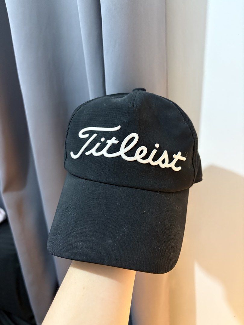 Titleist Black Golf Cap (Category: Caps & Hats) located in Manila. Submitted by aeshie_ (Listing ID 1466892167, Image 1). Description: Needs washing as it’s been stored for a while. - Brand: Titleist - Color: Classic black with raised white script logo - Breathable: Mesh lining inside for comfort during long rounds - Fit: Adjustable velcro strap at the back with a stylish tri-color stripe detail - Condition/Details: Clean interior sweatband featu