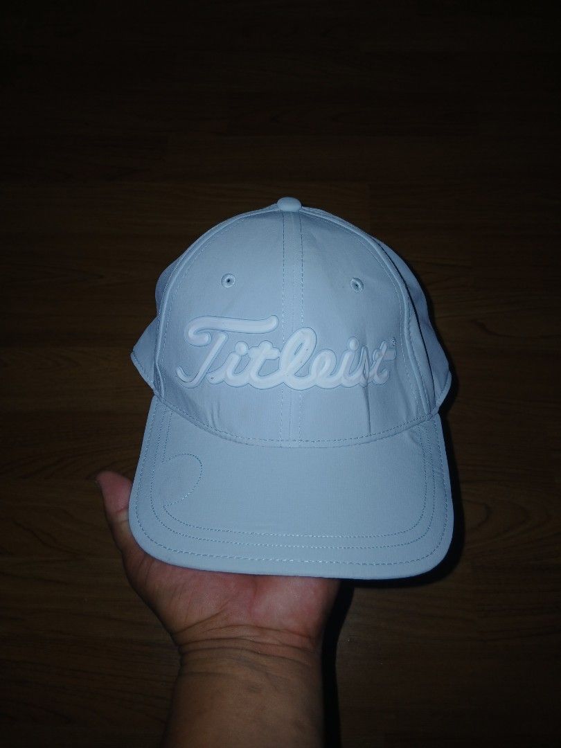 Titleist Golf Cap Light Blue Adjustable (Category: Caps & Hats) located in General Santos City (Dadiangas). Submitted by afsph1996 (Listing ID 1464872023, Image 1). Description: - Brand: Titleist -Size Medium to Large - Color: Light blue with white raised embroidered lettering - Fit: Adjustable velcro strap closure in the back - Material: 91% polyester, 9% spandex for comfort and stretch - Details: Features a black sweatband with repeating brand 