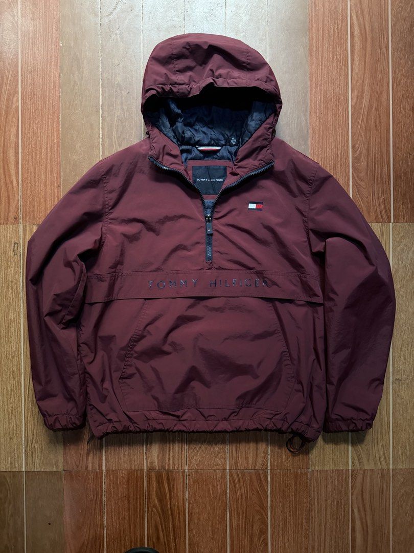 Tommy Hilfiger Maroon Anorak Windbreaker Jacket (Category: Coats, Jackets and Outerwear) located in Dasmarinas. Submitted by kylebecker (Listing ID 1466951399, Image 1). Description: - Brand: Tommy Hilfiger - Style: Half-zip anorak windbreaker - Color: Deep maroon red with dark navy quilted lining - Size: XL - Features: Attached hood with drawstrings, large front pouch pocket with embroidered lettering, left chest flag logo patch, elastic cuffs a