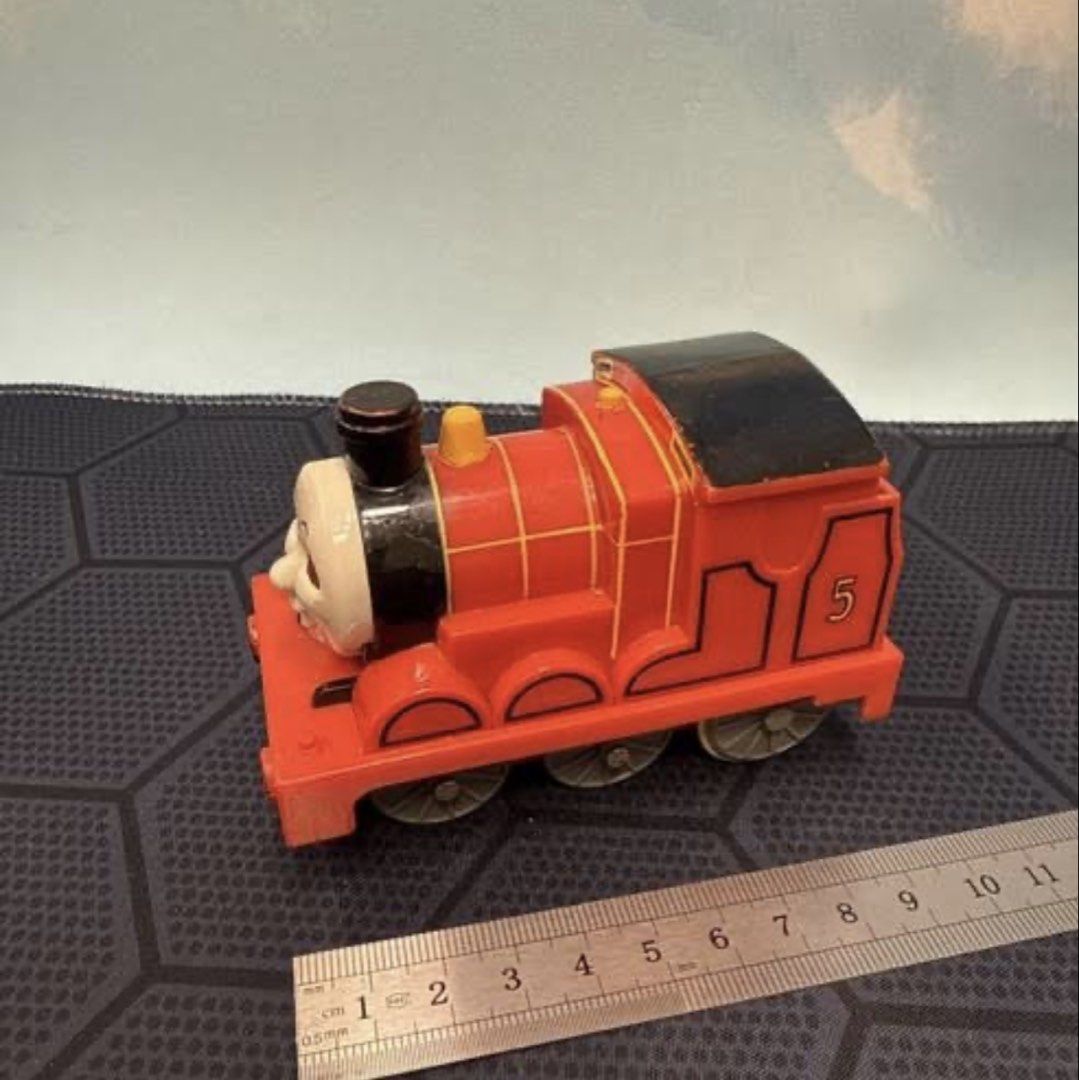 TOMY James The Red Engine Thomas & Friends Train (Category: Vehicle & Diecast Models) located in Manila. Submitted by lynnalec25 (Listing ID 1466815269, Image 2). Description: - Brand/Model: TOMY James the Red Engine (Number 5) - Origin & Year: Made in Vietnam, copyright 2004 Gullane Thomas Limited - Design: Classic red body, black funnel and cab roof, grey wheels, with bottom TOMY stamp - Size: Approximately 9 cm long - Condition/Use: Perfect fo