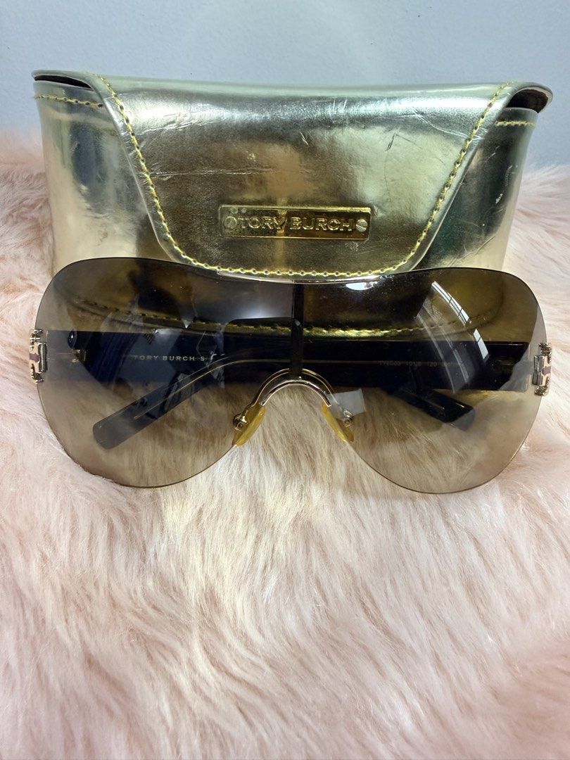 Tory Burch Shield Sunglasses with Gold Case (Category: Sunglasses & Eyewear) located in Quezon City. Submitted by shaberbree (Listing ID 1466908671, Image 1). Description: - Brand: Tory Burch - Style: Shield sunglasses with gradient brown tint - Frame: Dark tortoiseshell arms with gold Tory Burch logo hardware at hinges - Model No: TY6003 101/8 120 3N - Inclusion: Matching metallic gold hard case with embossed Tory Burch plaque - Condition: Well-