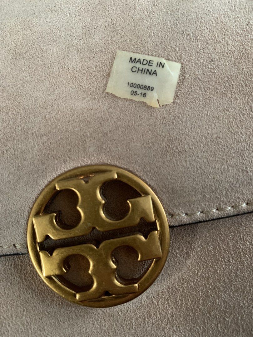 Tory Burch Suede Shoulder Bag with Gold Chain (Category: Purses & Pouches) located in Naga. Submitted by purestar_229e8f (Listing ID 1466862693, Image 3). Description: - Brand: Tory Burch - Style: Shoulder bag with gold-tone chain strap and hardware - Material: Beige suede exterior with fabric-lined interior - Details: Classic front flap with double T logo closure and interior gold logo plaque - Origin & Date: Made in China, tag date 05-16 - Cond