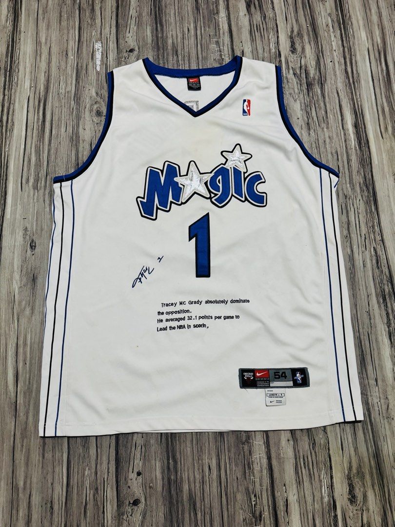Tracy McGrady Orlando Magic #1 White Jersey Size 54 (Category: Activewear) located in Quezon City. Submitted by lucky_wisefish.2ca7d6 (Listing ID 1466965788, Image 1). Description: - Team: Orlando Magic - Player: Tracy McGrady (#1) - Color: White with blue and black trim - Size: 54 (jock tag at bottom hem) - Brand: Nike (tag inside collar) - Special Features: Includes player signature and printed stats text on the front.