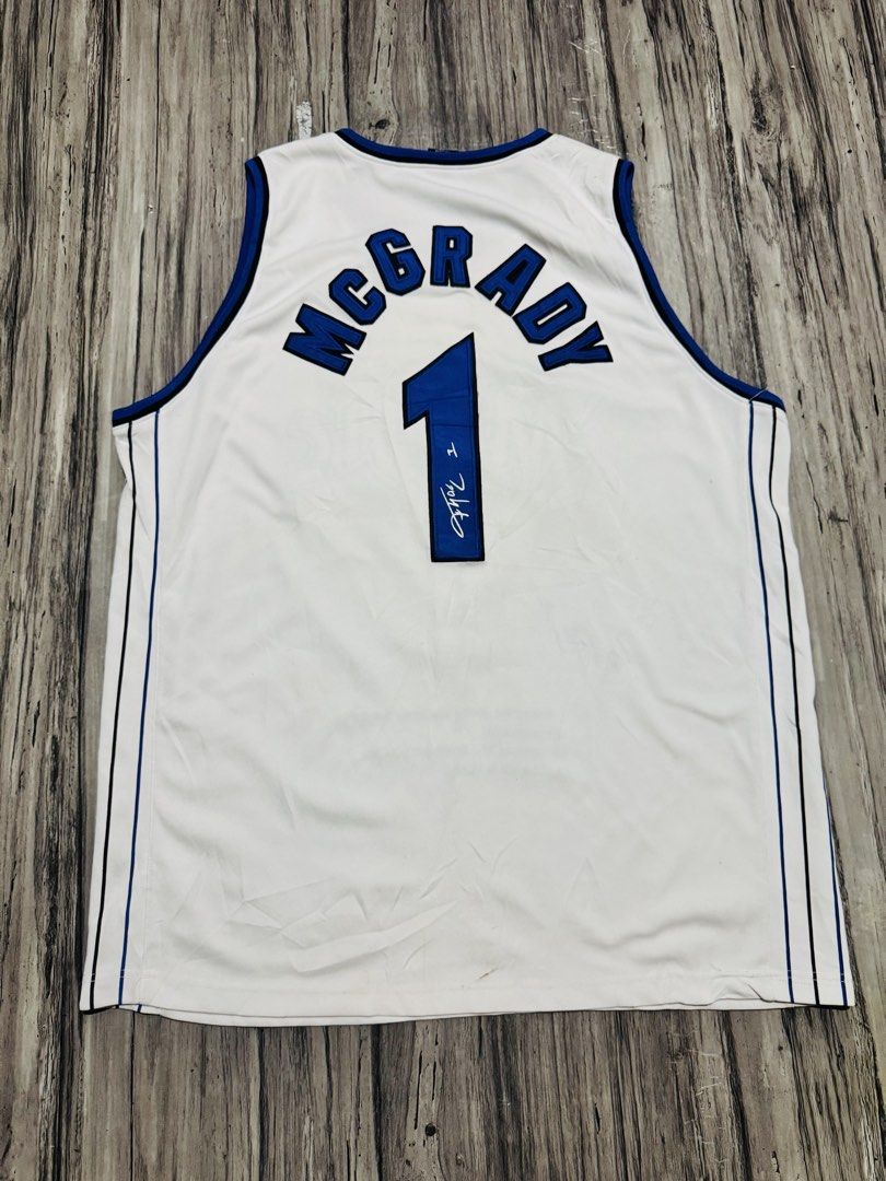 Tracy McGrady Orlando Magic #1 White Jersey Size 54 (Category: Activewear) located in Quezon City. Submitted by lucky_wisefish.2ca7d6 (Listing ID 1466965788, Image 2). Description: - Team: Orlando Magic - Player: Tracy McGrady (#1) - Color: White with blue and black trim - Size: 54 (jock tag at bottom hem) - Brand: Nike (tag inside collar) - Special Features: Includes player signature and printed stats text on the front.