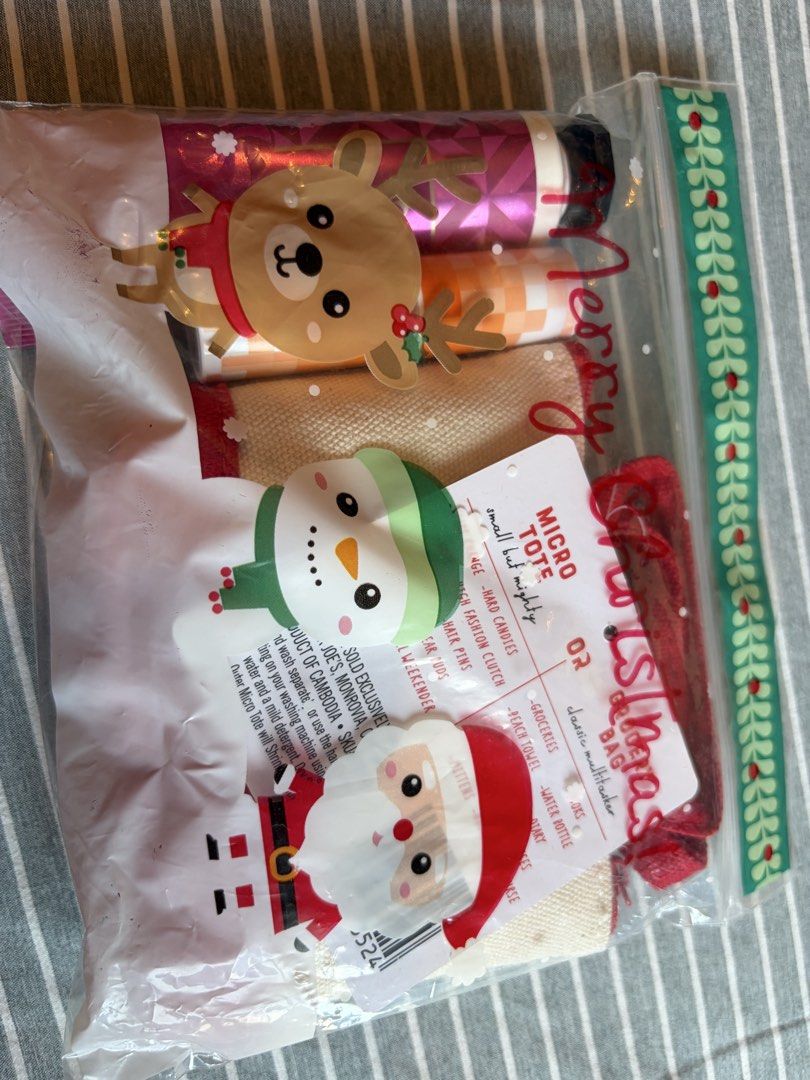 Trader Joe's Canvas Micro Tote Gift Set with Extras (Category: Tote Bags) located in Quezon City. Submitted by mmiyah27 (Listing ID 1466793100, Image 2). Description: - Brand new with tags (BNWT) Trader Joe's canvas micro tote bag with red trim, handles, and zipper closure (SKU 82352) - Includes a handy grocery bag tucked inside the tote - Bath & Body Works Twisted Peppermint shea butter hand cream (1 fl oz) - Clinique lipstick included - Beautif