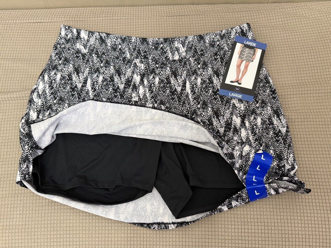 Tranquility Black White Printed Athletic Skort Size Large (Category: Activewear) located in Quezon City. Submitted by tinamartinez (Listing ID 1466871395, Image 2). Description: - Brand: Tranquility - Condition: Brand new with tags (BNWT) - Design: Black and white abstract print - Features: Built-in black shorts for extra coverage and comfort - Waistband: Wide and comfortable with printed brand/size info - Material: Polyester and spandex blend.