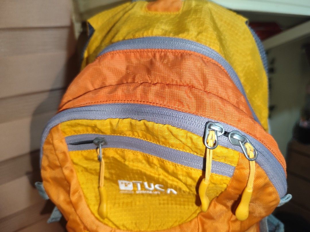 TUCA Taurus 25 Outdoor Backpack Orange Yellow (Category: Backpacks) located in Naga. Submitted by semflewer (Listing ID 1466831401, Image 2). Description: - Eye-catching orange and yellow TUCA Taurus 25 backpack - Durable ripstop fabric built for daily use and outdoor trails - Multiple front zippered compartments for easy organization - Breathable mesh side pockets for water bottles - Comfortable padded mesh shoulder straps with adjustable sternu