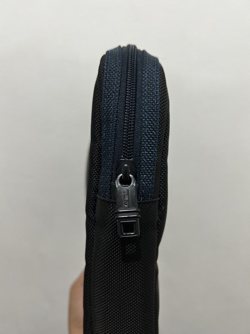 Tumi Black Laptop Sleeve Pouch (Category: Laptop Bags & Sleeves) located in Angeles City. Submitted by cassey_phoenix (Listing ID 1466906569, Image 3). Description: - Authentic Tumi laptop sleeve in classic black with blue zipper details - Padded interior safeguards your device from scratches and bumps - Built to last with durable ballistic nylon exterior for daily wear - Slim and compact design fits effortlessly into backpacks or briefcases - Fi