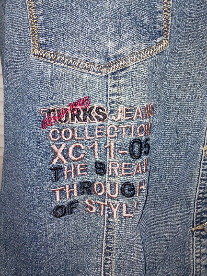Turks Jeans Collection Denim Jacket (Category: Coats, Jackets and Outerwear) located in Quezon City. Submitted by rdonelle (Listing ID 1466859846, Image 2). Description: - Classic blue denim jacket featuring a stylish contrast stitch design - Equipped with functional chest pockets and durable metal buttons - Unique embroidered text on the lower front: 'Turks Jeans Collection XC11-05 The Break Through of Style' - Long sleeves with secure button cu