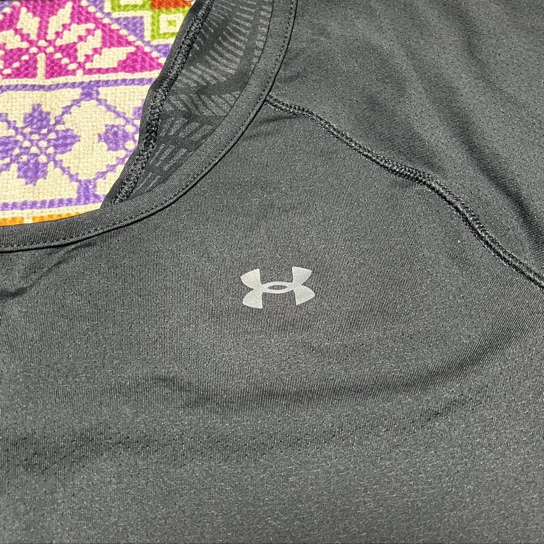 Under Armour Black Athletic T-Shirt (Category: Activewear) located in Dagupan City. Submitted by vernzkee (Listing ID 1466821375, Image 3). Description: - Brand: Under Armour - Color: Classic Black - Fit: Women's activewear (approx. 17" chest width, 25" length) - Material: Breathable mesh fabric with flat seams to prevent chafing - Design: Chic open back panel with unique patterned inner collar and hem trim - Ideal For: Gym workouts, running, and