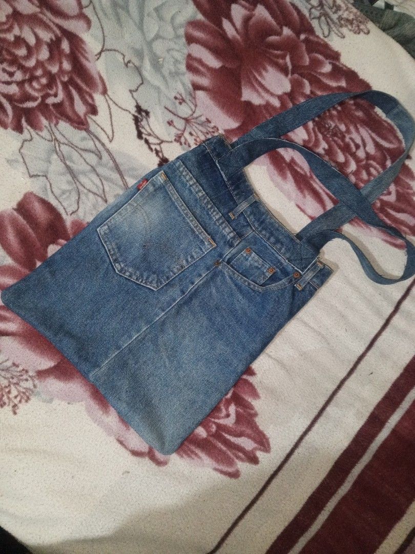 Upcycled Levi's Denim Tote Bag (Category: Tote Bags) located in Baguio. Submitted by tyrontoler83676 (Listing ID 1466933096, Image 2). Description: - Made from upcycled genuine blue Levi's jeans - Features actual back pockets and a front coin pocket - Equipped with secure double denim shoulder straps - Spacious interior for daily essentials, books, or groceries - Raw, casual, and sustainable everyday bag.
