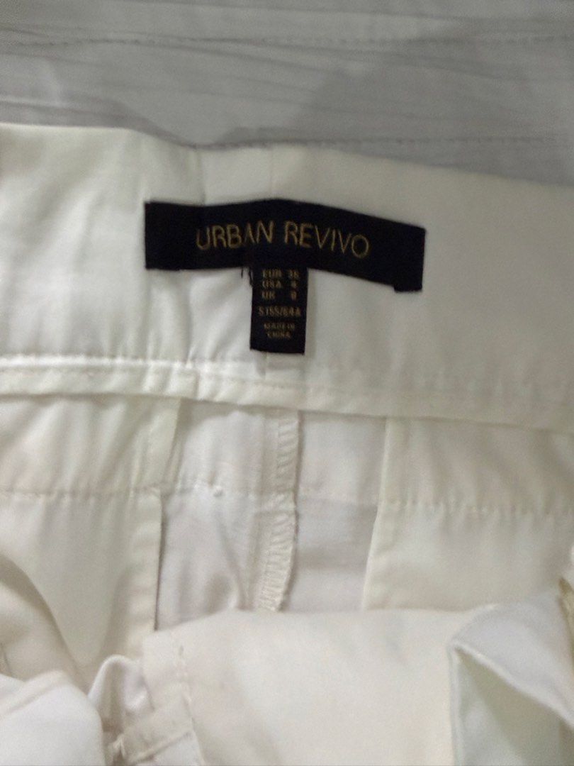 Urban Revivo White Trousers Size S (Category: Jeans) located in Quezon City. Submitted by afternoonstore (Listing ID 1466840887, Image 2). Description: - Brand: Urban Revivo - Style: High-waisted trousers with structured front pleats - Size: Small (EUR 36, US 4, UK 8) - Material: Lightweight fabric - Design: Clean, minimalist look - Condition: Brand new / Like new - Perfect for: Everyday wear, easily pairs with basic tops or blouses.