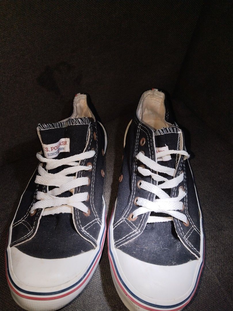US Polo Assn Black Canvas Sneakers (Category: Sneakers) located in Manila. Submitted by corndogsshopitem.8o67 (Listing ID 1466835457, Image 1). Description: - Brand: US Polo Assn. - Style: Black canvas low top sneakers - Details: White embroidered polo logo, white laces, rubber toe cap, red and blue midsole trim - Interior: Fabric lining with branded insoles - Condition: Pre-owned with visible wear and dirt on translucent outsoles, plus minor dis