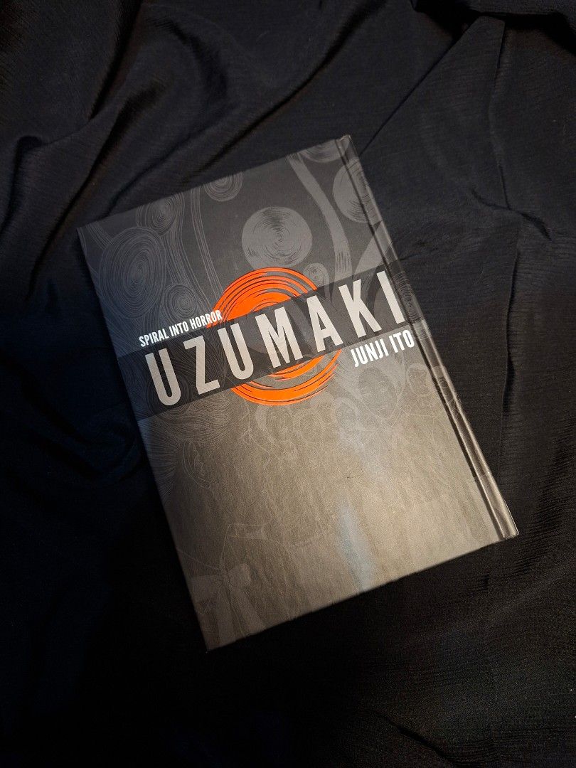 Uzumaki by Junji Ito Hardcover (Category: Comics & Manga) located in Makati City. Submitted by greycrowhouselibrary (Listing ID 1466877662, Image 1). Description: Uzumaki hardback edition by Junji Ito. Published by Viz Media Signature. Classic horror manga collecting the complete story in a single hardcover volume. Clean pages, solid binding, minimal shelf wear on the cover. Great read for horror fans and manga collectors alike..