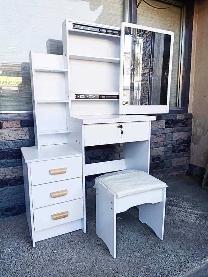 Vanity Table with Mirror and Stool (Category: Tables & Sets) located in Manila. Submitted by jamfrimzy089458 (Listing ID 1466843832, Image 2). Description: - Complete set: Includes dressing table, matching stool, mirror, and built-in storage drawers - Ample storage: Features multiple open side shelves for skincare and makeup - Secure main drawer: Spacious drawer comes with a key lock for privacy - Space-saving design: Compact size fits easily in 