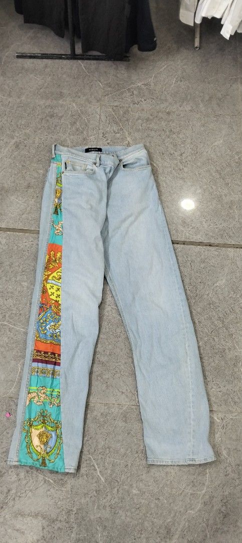 Versace Light Blue Jeans with Colorful Baroque Silk Side Panel (Category: Jeans) located in Manila. Submitted by hurleydediamante0513 (Listing ID 1466820421, Image 2). Description: - Brand: Versace - Style: Classic straight leg denim jeans with unique silk panel accent - Design: Light wash denim featuring a vibrant, colorful baroque print running down the left leg and back waistband - Details: Branded metal zipper and signature Versace waistband 