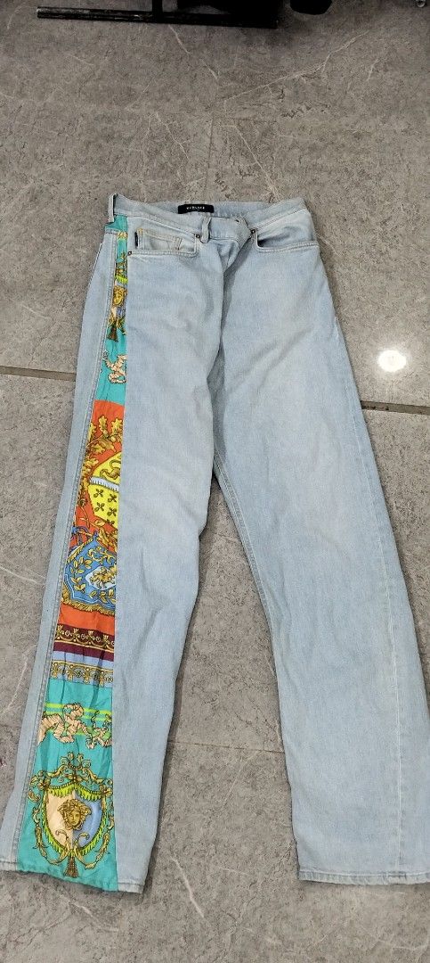 Versace Light Blue Jeans with Colorful Baroque Silk Side Panel (Category: Jeans) located in Manila. Submitted by hurleydediamante0513 (Listing ID 1466820421, Image 3). Description: - Brand: Versace - Style: Classic straight leg denim jeans with unique silk panel accent - Design: Light wash denim featuring a vibrant, colorful baroque print running down the left leg and back waistband - Details: Branded metal zipper and signature Versace waistband 