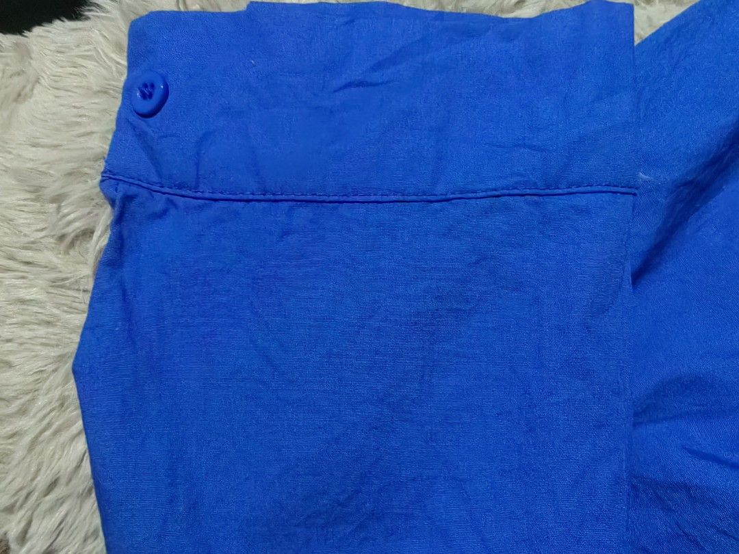 Vibrant Blue Button-Up Shirt with Pocket (Category: Blouses) located in Donsol. Submitted by saksthriftavenuebyluckymaria8 (Listing ID 1466947293, Image 3). Description: - Color: Bright blue - Style: Classic collar, button-down - Sleeves: Long sleeves with buttoned cuffs - Details: Single chest pocket on the right, curved hemline - Versatility: Great for layering or standalone casual and smart-casual outfits sz L chest 24in armhole 10in shoulder 