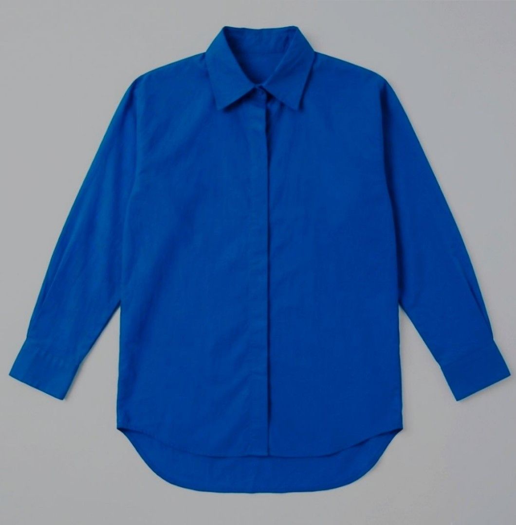 Vibrant Blue Button-Up Shirt with Pocket (Category: Blouses) located in Donsol. Submitted by saksthriftavenuebyluckymaria8 (Listing ID 1466947293, Image 2). Description: - Color: Bright blue - Style: Classic collar, button-down - Sleeves: Long sleeves with buttoned cuffs - Details: Single chest pocket on the right, curved hemline - Versatility: Great for layering or standalone casual and smart-casual outfits sz L chest 24in armhole 10in shoulder 