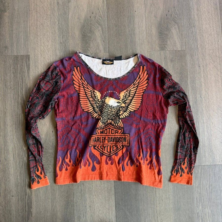 Vintage 00s Harley Davidson AOP Flame & Eagle Design* (Category: Longsleeves) located in Cabuyao City. Submitted by roronhilira (Listing ID 1466968450, Image 1). Description: Vintage 00s Harley Davidson AOP Flame & Eagle Design* Women Tops 2W size tag 23 pit to pit 26 length very good condition 1200 shipped DM 📥.