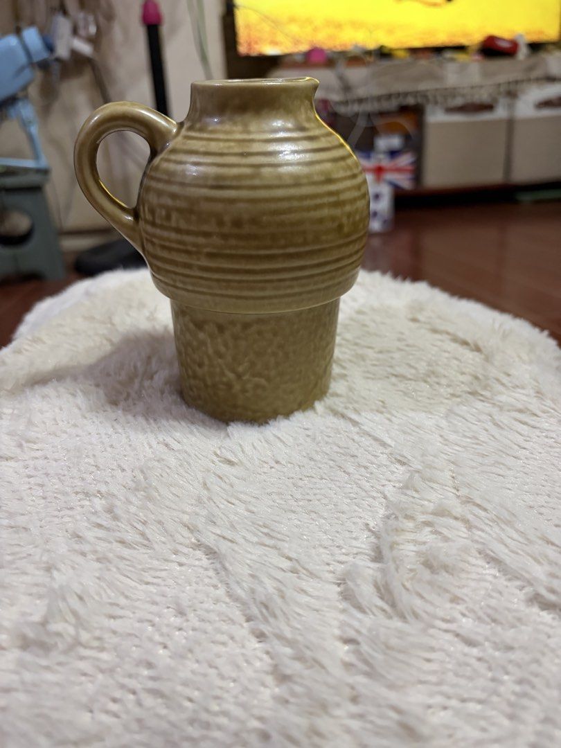 Vintage Ceramic Jug with Handle (Category: Pitchers & Dispensers) located in Manila. Submitted by lynnalec25 (Listing ID 1466813426, Image 2). Description: - Type: Ceramic jug with single side handle - Finish: Two-tone brown with a high-gloss glaze - Design: Ribbed upper body and textured lower cylinder with a small pouring opening - Versatile Use: Ideal for home styling or as a vase for flower arrangements - Condition: Excellent, display-ready.
