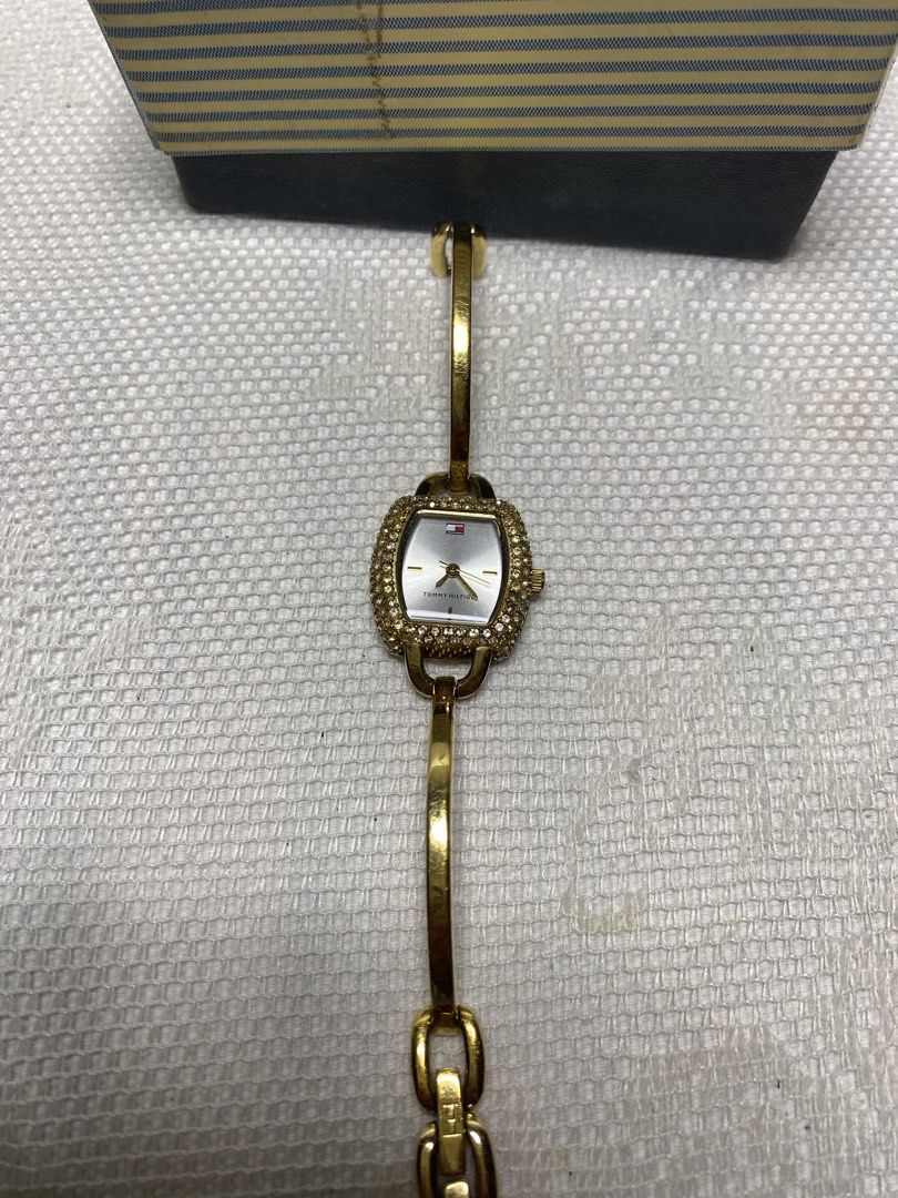 Vintage Tommy Hilfger watch (Category: Women's Watches) located in Angeles City. Submitted by noagrace (Listing ID 1466786534, Image 2). Description: Vintage Tommy Hilfiger women’s bangle-style analog watch Gold plated rhinestone crystal-set bezel Missing few crystals No battery Complete with box P1800.