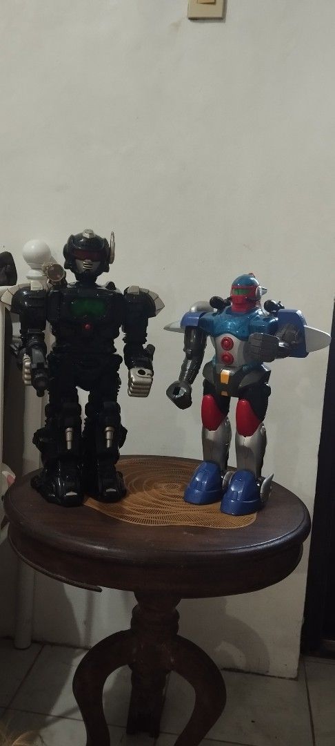 Vintage Toy Robot Action Figures (Category: Action & Battle Toys) located in Manila. Submitted by ventajetoyz625 (Listing ID 1466806564, Image 1). Description: - Vintage-style robot action figures - P499.00 each - Robot 1: Sleek black design with striking green chest armor and red visor; 17 inches tall - Robot 2: Classic blue, red, and silver colorway featuring an open cockpit with a mini pilot figure; 15 inches tall - Perfect for desk display, s