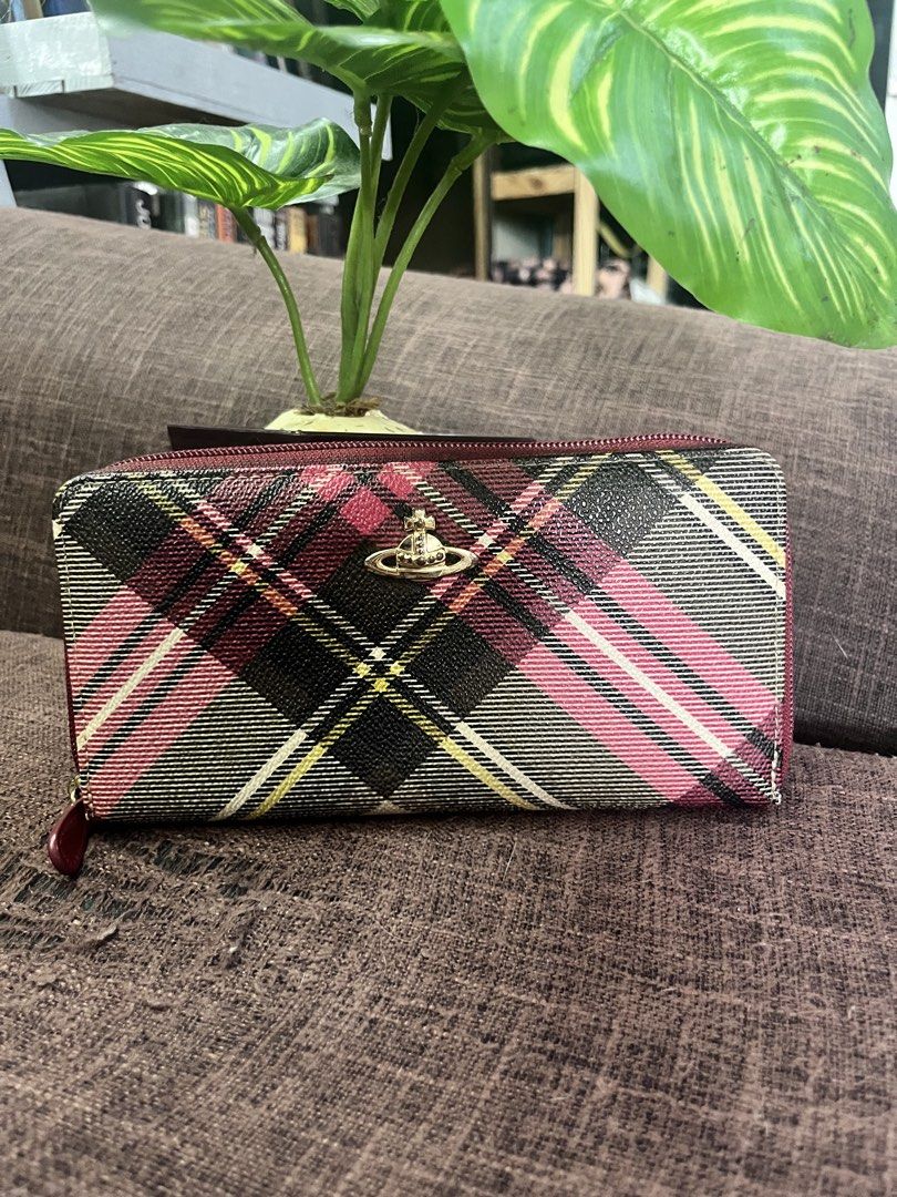Vivienne Westwood (Category: Luxury Bags & Wallets) located in Quezon City. Submitted by retann (Listing ID 1466777723, Image 1). Description: - Thrifted in HK - Classic pink, red, black, and white tartan plaid - Iconic gold-tone front orb logo - Deep red zip-around with matching pull tab - Spacious compartments for cards, cash, and coins - Condition: Excellent daily carry piece - Mode of Payment: BPI / GCash / Maya - Shipping: J&T Express or Sam
