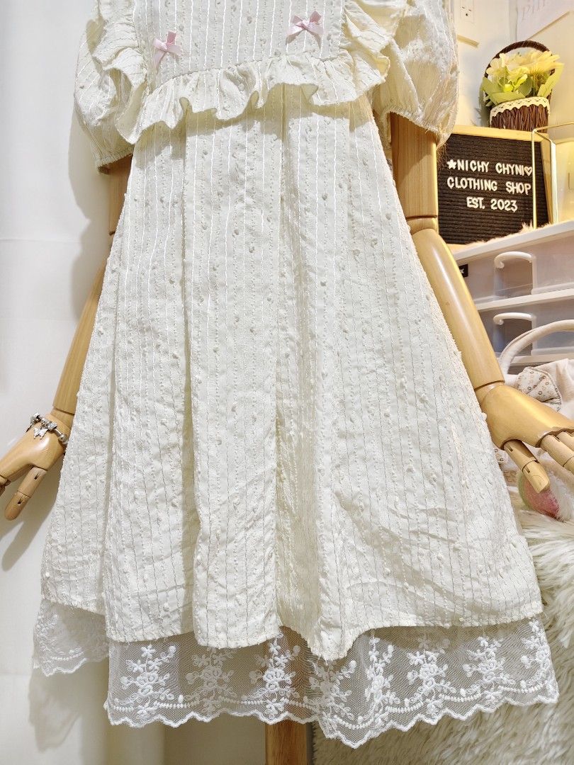 Vlovelan Pink Bow White Dress (Category: Dresses) located in Manila. Submitted by chynii_28 (Listing ID 1466865741, Image 3). Description: - Brand: Vlovelan - Color: White with pink collar and bow accents - Details: Ruffles and lace hem at the bottom - Measurements: Bust 36" | Waist 36" | Length 34" - Condition: Like new, no flaws found - Style: Cute, sweet, and feminine.