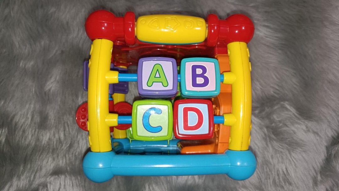 VTech Busy Learners Activity Cube 850 pesos (Category: Infant Playtime) located in Agdangan. Submitted by strawberryvanilla9 (Listing ID 1466828228, Image 3). Description: - Multi-sided VTech activity cube designed for toddlers - Features letter blocks, numbers, animals, shapes, and musical buttons - Includes sliding elements and a battery-operated interactive top panel - Designed with bright primary colors (red, yellow, blue, and green) - Great 