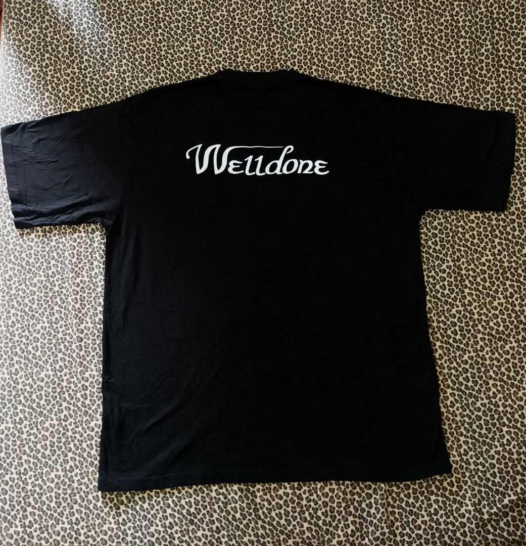 We11done Black Logo T-Shirt Size M (Category: Tshirts & Polo Shirts ) located in Davao. Submitted by jasondagam14678 (Listing ID 1466784696, Image 3). Description: - Brand: We11done - Color: Black - Size: Medium - Design: Large oval chest graphic logo with smaller cursive branding on the upper back - Details: Classic crew neck, short sleeves, woven inner collar tag, and interior care label - Material: Premium cotton - Condition: Excellent, well-m