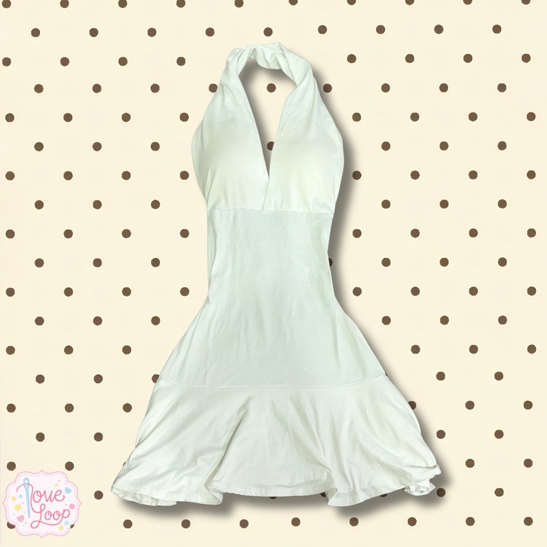 White Halter Neck Dress with Ruffle Hem (Category: Dresses) located in Manila. Submitted by love.loop (Listing ID 1466889454, Image 1). Description: - Color: Crisp white - Style: Halter neck, deep V-neck, backless mini dress - Fit: Fitted bodice with a flared ruffle hem - Fabric: Lightweight and breathable for warm weather - Versatility: Easy to style for both casual days and nights out - Closure: Slip-on style.