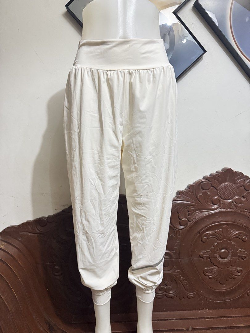 White High-Waisted Cuffed Jogger Pants (Category: Jeans) located in Marikina City. Submitted by lorradel (Listing ID 1466808344, Image 1). Description: - fits 27-29 in waist - Color: White - Fit: Relaxed through hips and thighs with tapered, cuffed ankles - Waist: Wide, high-waist band with easy pull-on style - Fabric: Soft and lightweight for all-day comfort - Details: Subtle reflective tape near the left hem - Best for: Lounging, errands, or li