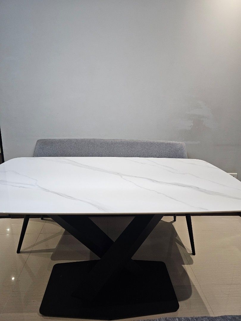 White Marble Pattern Dining Table (Category: Tables & Sets) located in Singapore. Submitted by mummyiren (Listing ID 1466928362, Image 3). Description: - White dining table with stylish sintered stone top - Sturdy black metal cross legs and flat rectangular base for maximum stability - Modern minimalist design, perfect for contemporary homes - Clean surfaces with minimal signs of wear.