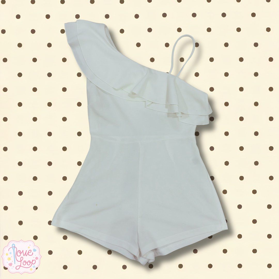 White One-Shoulder Ruffle Romper (Category: Rompers) located in Manila. Submitted by love.loop (Listing ID 1466889827, Image 1). Description: - Color: Clean solid white - Design: Asymmetric one-shoulder with extra thin strap and ruffle overlay front to back - Fit: Fitted waist seam with built-in shorts - Material: Smooth, comfortable fabric - Versatility: Perfect for warm weather, casual outings, or parties; style with heels or sandals.