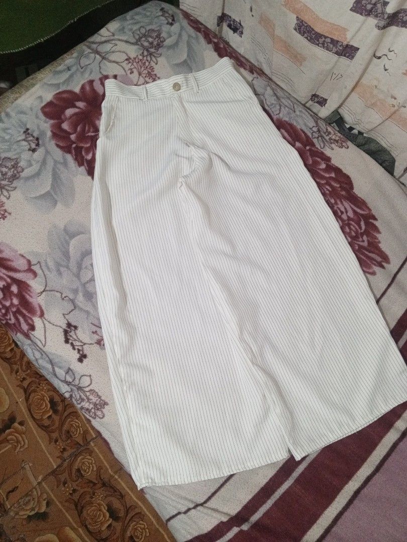White pinstripe wide leg trousers with button closure (Category: Trousers) located in Baguio. Submitted by tyrontoler83676 (Listing ID 1466932902, Image 1). Description: ‎White Stripe baggy Pants ‎Length 40 inches ‎Waistline 30 inches ‎Leg opening 14 inches ‎Tight 15 inches - Color/Pattern: White with black vertical pinstripes - Fit: Wide leg, high waist style with belt loops and single front button closure - Pockets: Two practical side pockets -