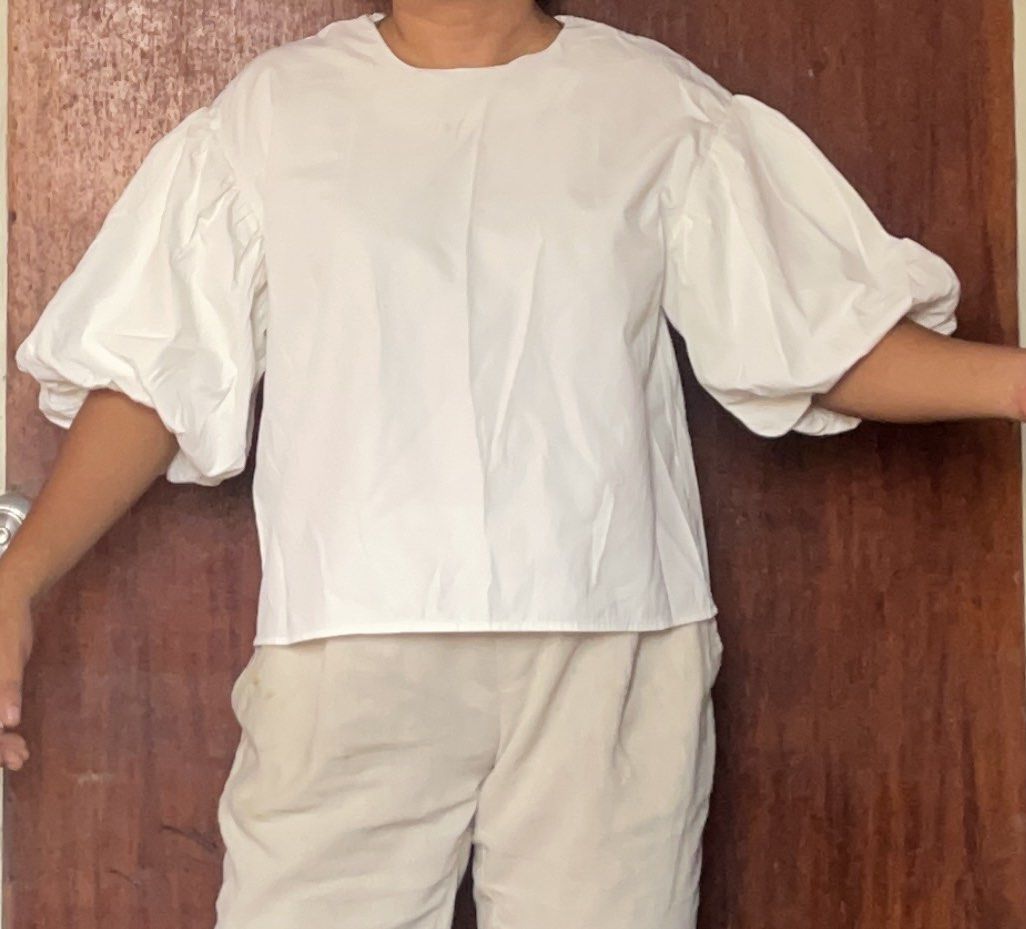 White Puff Sleeve Blouse (Category: Blouses) located in Toledo. Submitted by klnmia (Listing ID 1466863545, Image 1). Description: - Color: Classic White - Design: Dramatic voluminous puff sleeves with a round neckline - Fit: Relaxed, boxy cut through the body - Material: Lightweight, breathable woven fabric - Finish: Clean finished hems inside and out - Styling: Versatile piece, easy to pair with casual trousers or skirts.