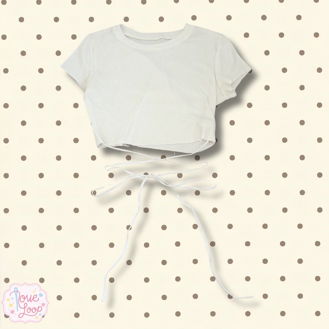 White Ribbed Crop Top with Tie Back (Category: Sleeveless) located in Manila. Submitted by love.loop (Listing ID 1452780627, Image 1). Description: - White ribbed crop top - Short sleeves - Long back ties for adjustable waist cinching - Can be tied in a bow or knot - Simple and versatile design - Perfect for layering or wearing alone.