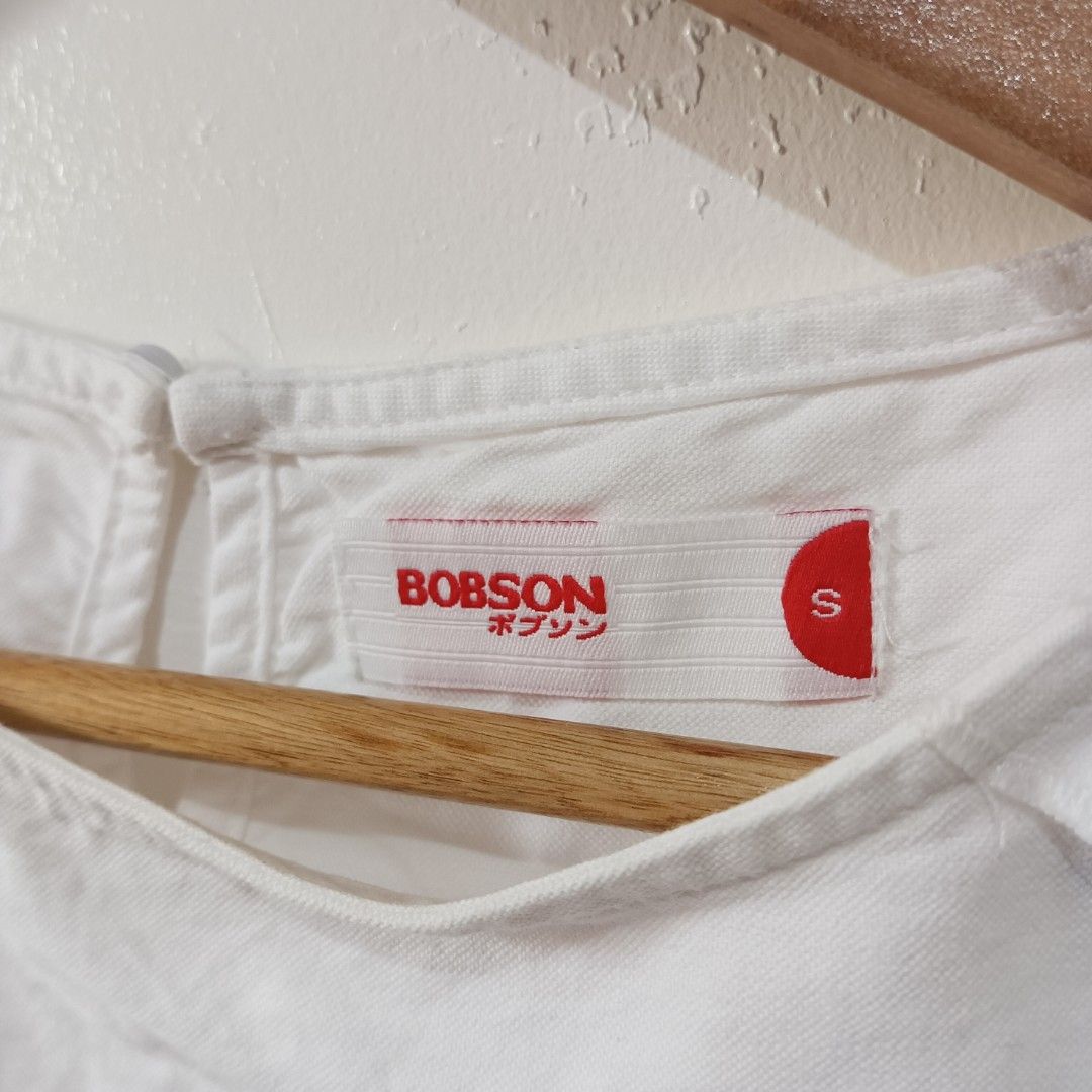 White Short-Sleeve Blouse | Bobson (Size S) (Category: Blouses) located in Subic. Submitted by mustardt_ (Listing ID 1466824278, Image 2). Description: Crisp white short-sleeve top featuring structured seam details, a rounded curved hem, and a back keyhole closure. has stain - need wash size: 18.5in x 19in code: c785.