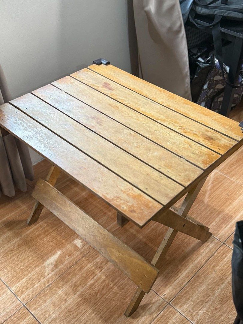 Wooden Foldable Table (Category: Tables & Sets) located in Bocaue. Submitted by pat.staines (Listing ID 1466780696, Image 1). Description: folding table that can fit 4 pax issue lng yung color nya, barnisan nyo nalang po pero all in all wala naman yan issue.