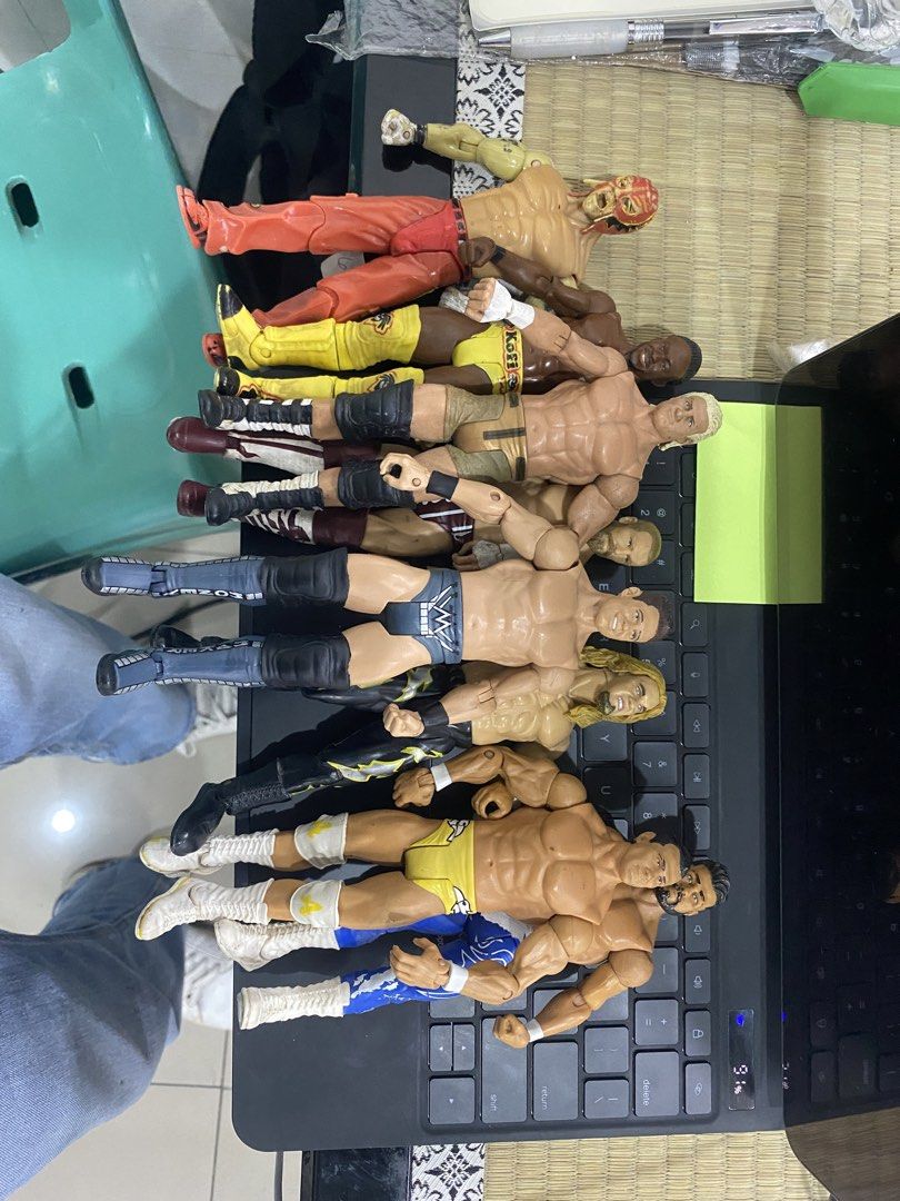 WWE Wrestling Action Figures Bundle Toy Lot (Category: Action & Battle Toys) located in Manila. Submitted by curlcyspreloved (Listing ID 1466886850, Image 1). Description: - Lot of WWE wrestling action figures - Features various wrestlers in different ring gear, knee pads, and boots - Colorful mix of characters in yellow, red, black, and blue outfits - Minor paint wear on some figures due to previous play - Great bundle for fans and collectors.