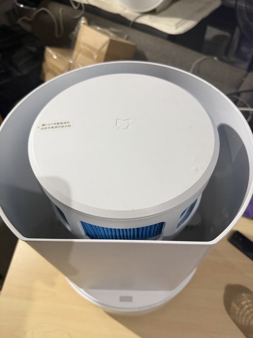Xiaomi Mijia Pure Smart Humidifier (Category: Air Purifiers & Dehumidifiers) located in Bulacan. Submitted by mysticdeer.6d7f47 (Listing ID 1466876172, Image 2). Description: The device in the image is a Xiaomi Mijia Pure Smart Humidifier (such as the Pro or Mist Free series), featuring a cylindrical white body, a top-mounted circular OLED display panel, and touch-sensitive control buttons. • Type: Evaporative (mist-free) smart humidifier • Key F