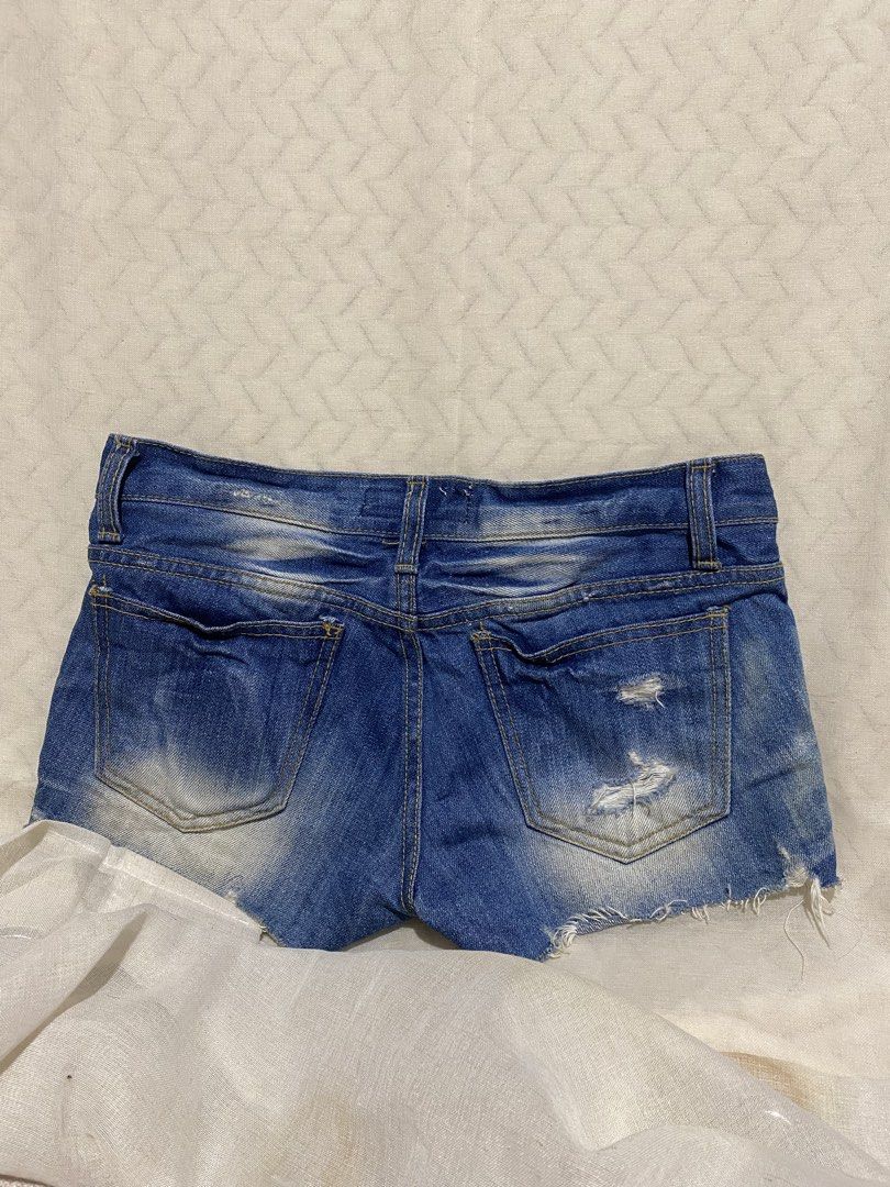 Y2K low-rise distressed denim micro shorts (Category: Shorts) located in Marilao. Submitted by kyssmarila (Listing ID 1466857163, Image 2). Description: — Size: Natural waist: 25” but because its low rise the exact waist measure is 28-29” — Rise: 6.5” — Length: 8.5” — Condition: 9/10 — Flaws: None.