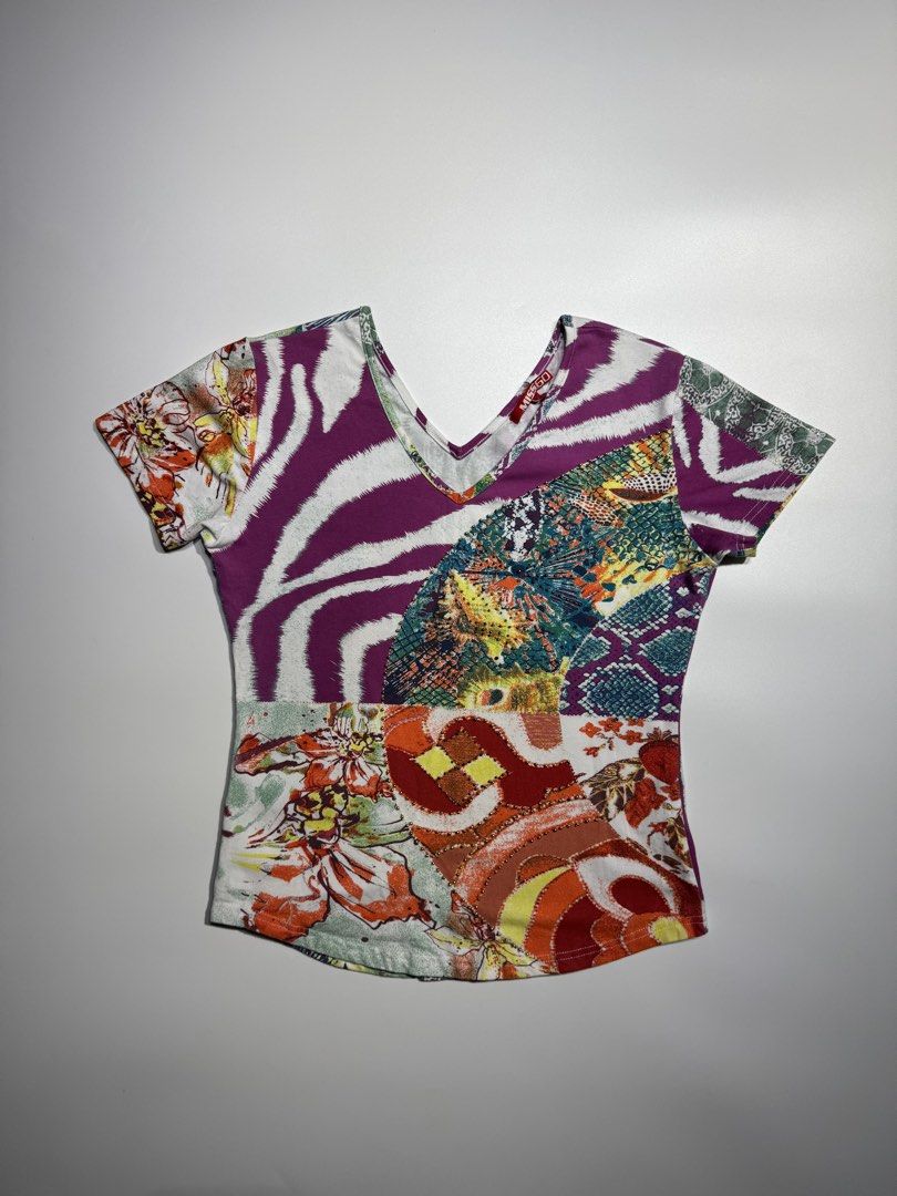 Y2K Miss Sixty Multi-Pattern Short Sleeve V-Neck Top Size S (Category: Shirts) located in Manila. Submitted by babygirly2k (Listing ID 1466836475, Image 1). Description: - Brand: Miss Sixty - Style: V-neck top with short sleeves - Design: Vibrant patchwork of animal, floral, and snake prints with delicate front stud embellishments - Fabric: Lightweight and stretchy - Size: Pit-to-pit approx. 18 inches - Condition: Great statement piece for casual