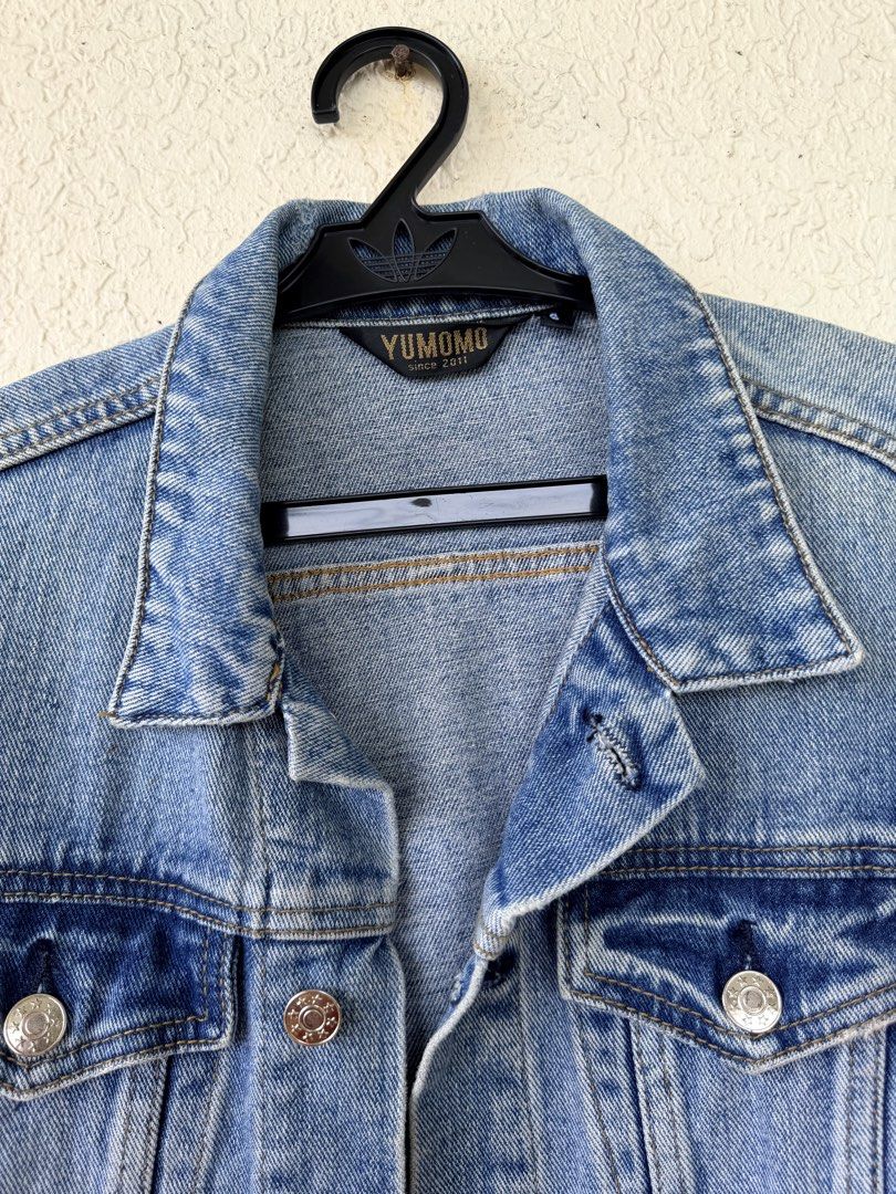 Yumomo Light Wash Cropped Denim Jacket (Category: Coats, Jackets and Outerwear) located in Tubigon. Submitted by gypsea.soulph (Listing ID 1466946941, Image 3). Description: - Brand: Yumomo - Wash: Light blue denim - Fit: Cropped, structured style with long sleeves - Details: Silver metal buttons and dual chest pockets - Hem: Trendy raw frayed hemline - Style: Great versatile layering piece.