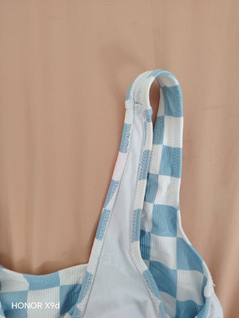 Zaful Checkerboard Knot Bikini Top (Category: Bikinis & Swimsuits) located in Mabalacat. Submitted by Jackikay.PreLoved (Listing ID 1466845860, Image 3). Description: - Bago pa but may hawa (pink, see pic 3) - Brand: Zaful - Style: Checkered bikini top with front tie knot - Color: Blue and white - Size: S (US 4, UK 8, EU 36) - Material: Ribbed polyester and spandex blend - Details: Scoop neck and thick straps - Care: Hand wash recommended.