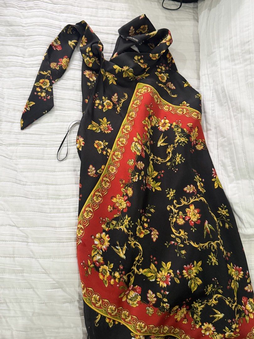 Zara Basic Floral Print Halter Dress (Category: Dresses) located in Quezon City. Submitted by afternoonstore (Listing ID 1466841718, Image 1). Description: - Brand: Zara Basic - Size: S - Color/Pattern: Black with red and yellow floral scarf print - Style: Halter neck with adjustable tie strap - Material: Soft satin-like fabric - Origin: Made in Morocco - Condition/Occasion: Great for summer parties or casual outings.